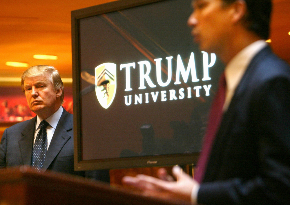 In this May 23, 2005 file photo, real estate mogul and TV star Donald Trump listens at left as Michael Sexton introduces him to announce the establishment of Trump University during a news conference in New York.