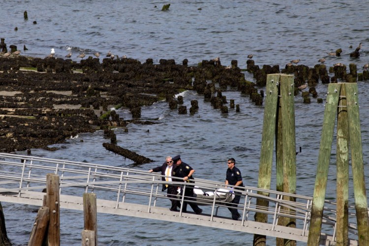 Portland police remove a body from Casco Bay on Monday.