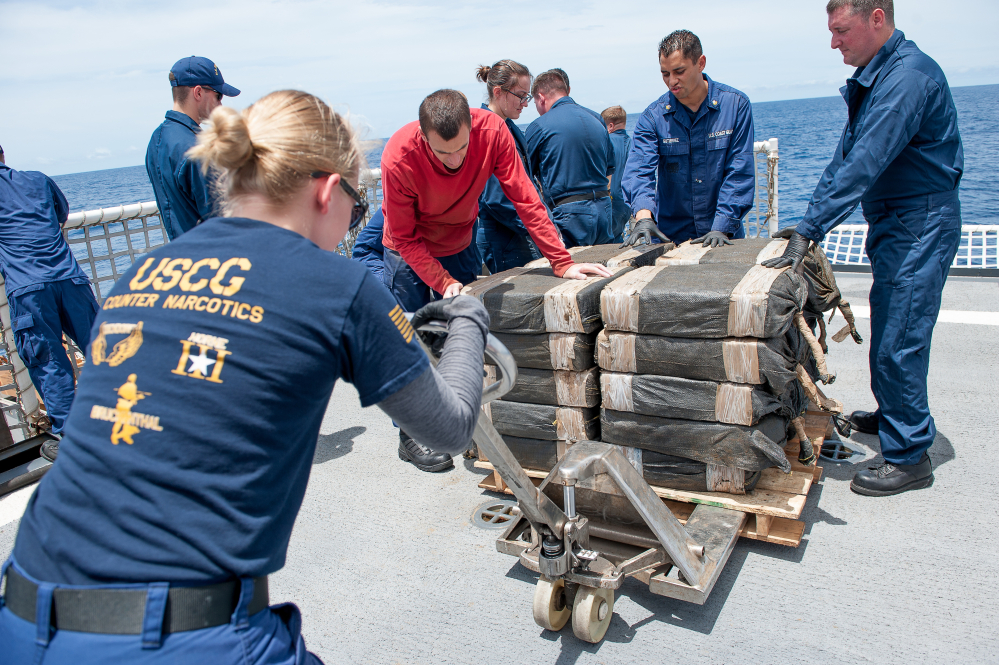 Crew members on the U.S. Coast Guard cutter Stratton secure cocaine bales taken from a semisubmersible in international waters off the coast of Central America in July.