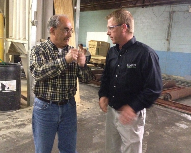 U.S. Rep. Bruce Poliquin, a Republican from Maine’s 2nd District, left, speaks with Brody Cousineau, vice president of Cousineau Wood Products, during a Tuesday tour of the company’s North Anson facility.