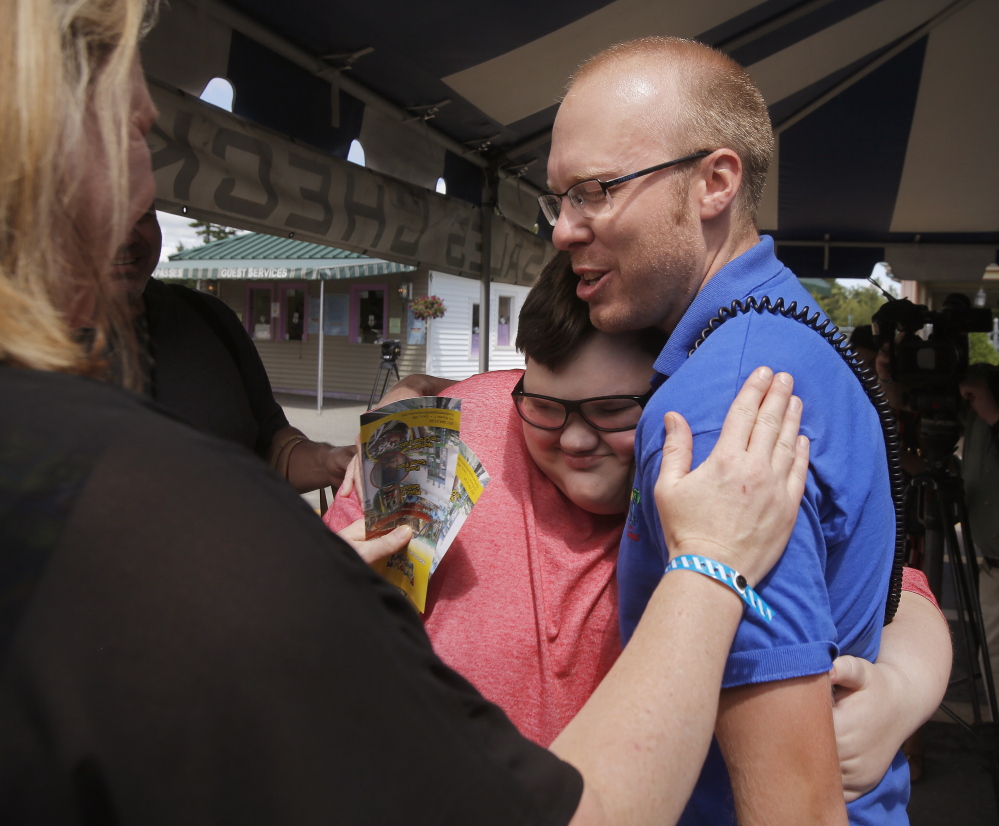 Dean Dylan, 11, hugs Ed Hodgdon, spokesman for Funtown/Splashtown USA, shortly after arriving at the Saco amusement park on Wednesday. Funtown/Splashtown USA flew Dylan, who has Asperger’s syndrome, and his family to Maine and gave them free passes to the park.