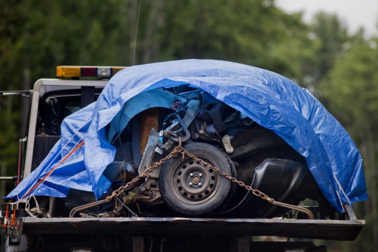 The mangled remains of the front of the 1993 Honda Civic that Michael Minson was driving on Aug. 11 are towed away from the scene.
Gabe Souza/Staff Photographer
