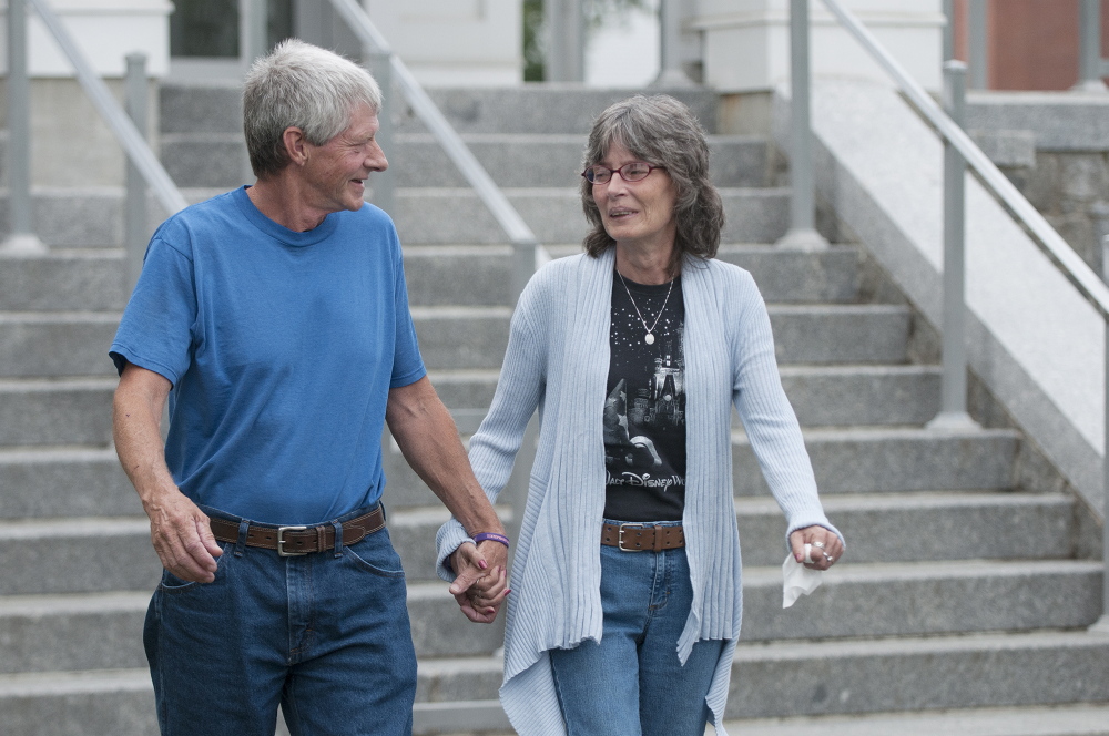 Vance Ginn, left, and his wife, Angel Ginn, leave Piscataquis County Superior Court on Wednesday after attending Robert Burton’s initial appearance in connection with the slaying of their daughter, Stephanie Gebo, in Parkman in June.
