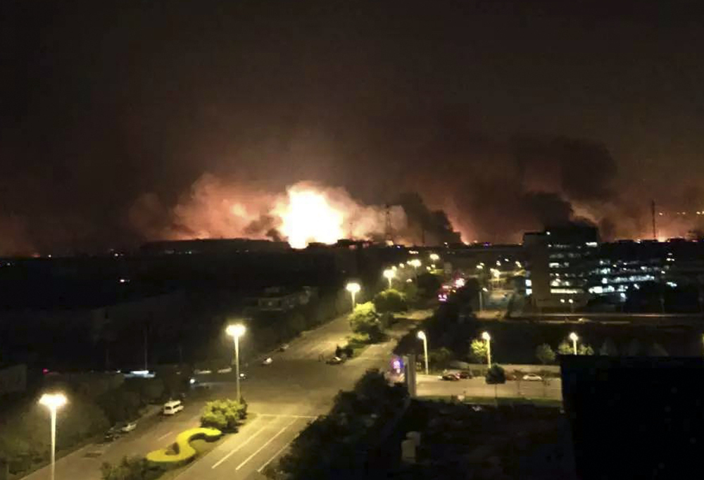 Smoke and fire erupt into the night sky after an explosion in north China’s Tianjin municipality Thursday. At least seven people died and hundreds of injured are being treated at nearby hospitals, officials reported.