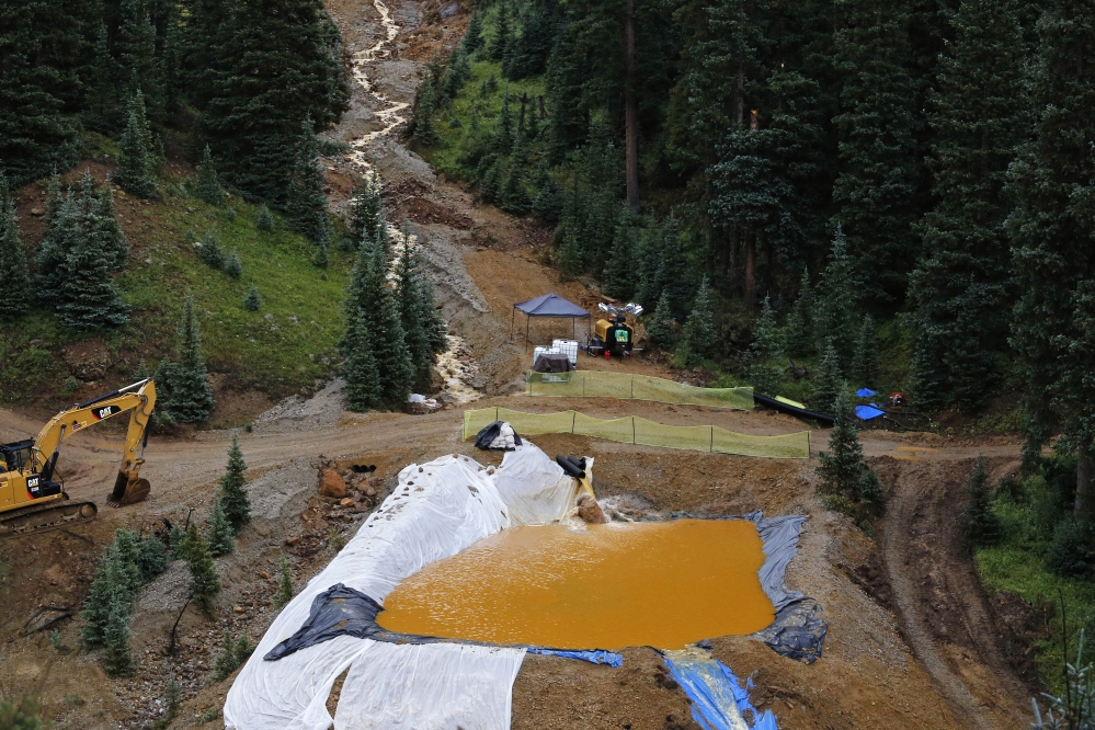 Water flows through one in a series of retention ponds built to contain and filter out heavy metals and chemicals from the Gold King mine wastewater accident, in the spillway about a quarter mile downstream from the mine, outside Silverton, Colo., Wednesday.