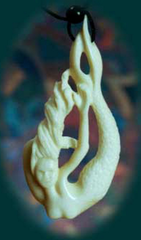 A mermaid carved from moose bone, above, and “Within,” below, carved to look like a wave. Val and Gerry Hoff make the jewelry in their Mount Vernon studio.