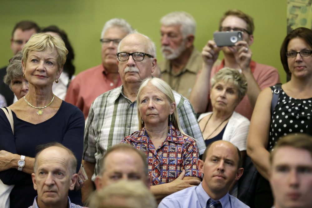Iowa residents listen as former Florida Gov. Jeb Bush speaks Thursday during a forum sponsored by the Americans for Peace, Prosperity and Security in Davenport, Iowa.