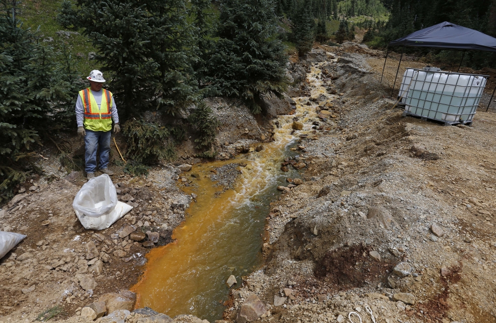 An Environmental Protection Agency contractor works on the cleanup in the aftermath of the blowout at the Gold King mine, which triggered a major spill of toxic wastewater, outside Silverton, Colo., on Wednesday.