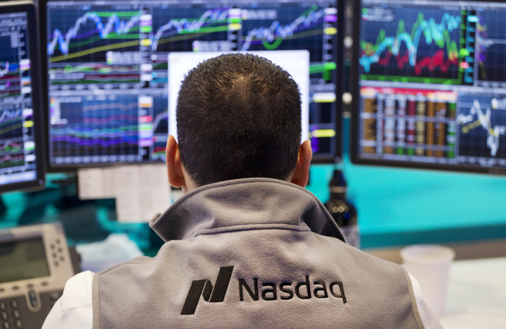A Nasdaq employee monitors prices at the Nasdaq MarketSite in New York. The tech-driven Nasdaq hit another in a string of all-time highs last month as technology re-established itself as the dominant sector in the U.S. stock market.