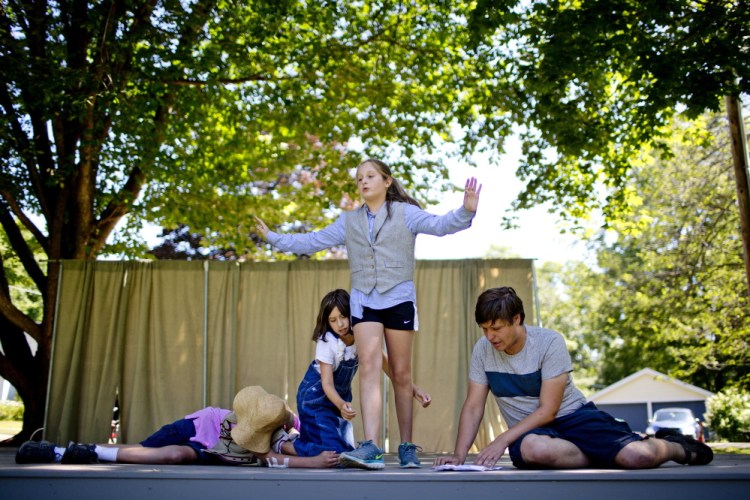 From left, Ian Pizey, 14, of Kennebunk, Sophie Weil, Maeve Sheehan, 11, of Kennebunk, and Kyle Walton, a staff member with MaineStage Shakespeare, rehearse a scene in Lafayette Park in Kennebunk on Friday.