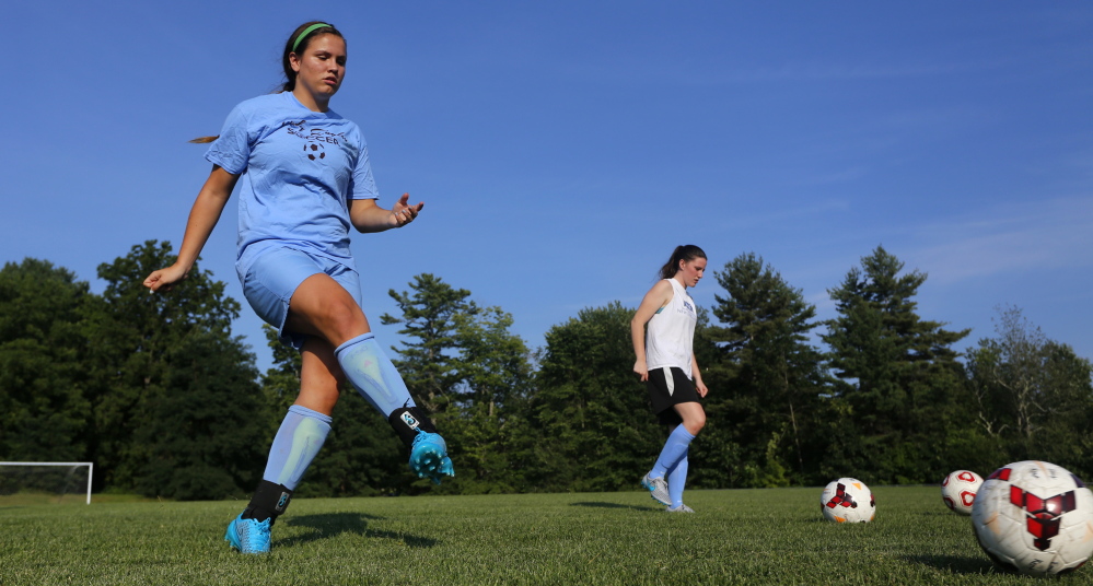 Windham seniors Cierra Berthiaume, left, and Sadie Nelson warm up on the first day of practice Monday in Windham. The Eagles are the two-time defending Class A state champions, but will need to overcome the graduation of eight players to win a third straight.