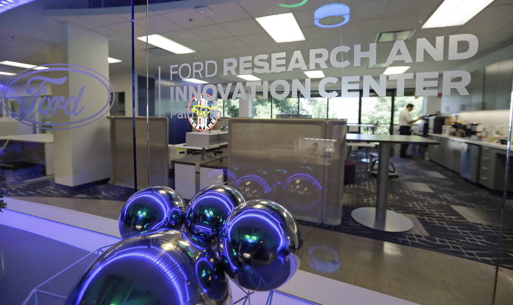 The convergence of cars and technology is blurring the traditional boundaries of both industries, as reflected here in the hip foyer of the Ford Motor Company Research and Innovation Center in Palo Alto, Calif.