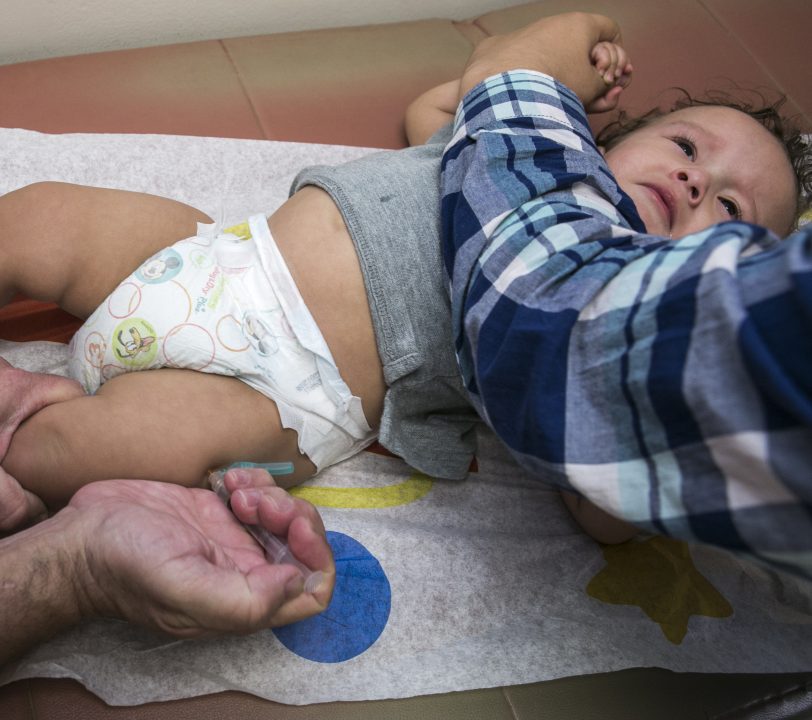 Pediatrician Charles Goodman vaccinates 1-year-old Cameron Fierro in Northridge, Calif., in January, after explaining the need for the immunization to the boy’s father. Maine’s highest court last week ruled that state officials can have a year-old child in their custody immunized. His mother objects, saying she does “not believe in viruses.”