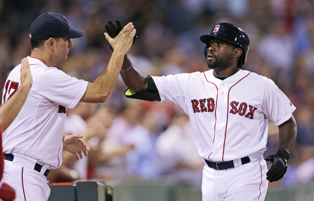 Boston’s Jackie Bradley Jr., right, is congratulated by Red Sox interim manager Torey Lovullo after his three-run home run off Cleveland Indians starting pitcher Corey Kluber in the fourth inning at Fenway Park in Boston on Wednesday.