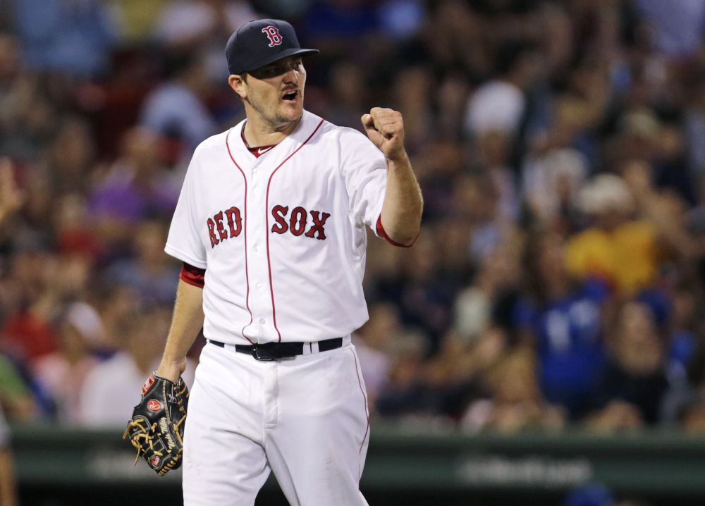 Red Sox starting pitcher Wade Miley pumps his fist after Mookie Betts snagged a a line drive by Kansas City’s Alex Rios to end the top of the seventh inning Thursday at Fenway Park.