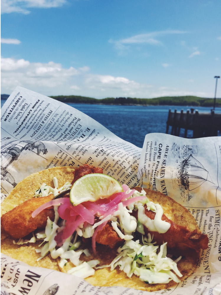 A fish taco and lobster roll. The lobster rolls are offered three ways.