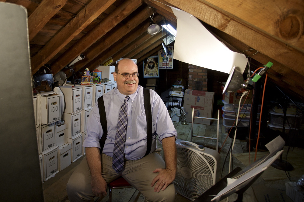 Chad Gilley in the attic of his South Portland home, where with painstaking care he stores the comic books that he has been collecting for more than 30 years.