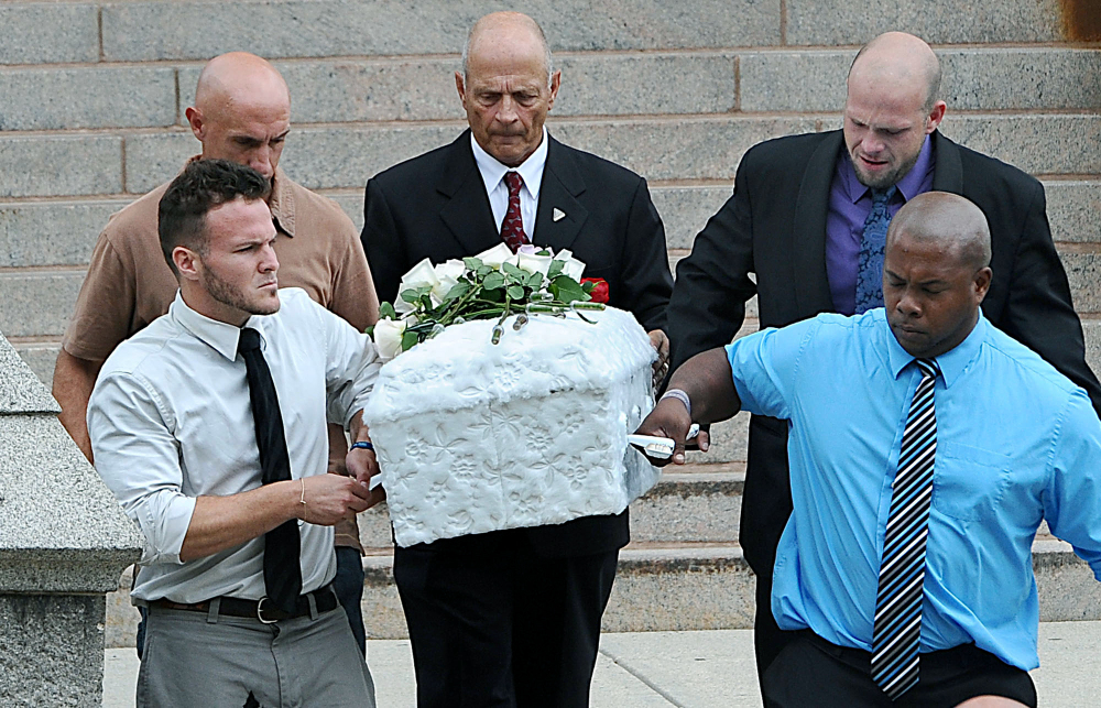 Pallbearers, including two-year-old Avalena Conway-Coxon’s father, Ronald E. Green, top right,  carry her casket from Immaculate Conception Church in Marlborough, Mass., on Friday, Aug. 21, 2015, following a funeral service.  Avalena died after being found unresponsive in an Auburn foster home on Saturday.  (Ken McGagh/The Metro West Daily News via AP) MANDATORY CREDIT