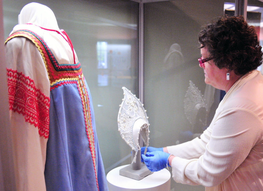 Laurie LaBar, chief curator of history for the Maine State Museum in Augusta, sets up a display of Samantha Smith items Thursday. “I think her story is as relevant as ever ... a story like this is refreshing because it shows you can make a difference, if you speak the truth,” she said.