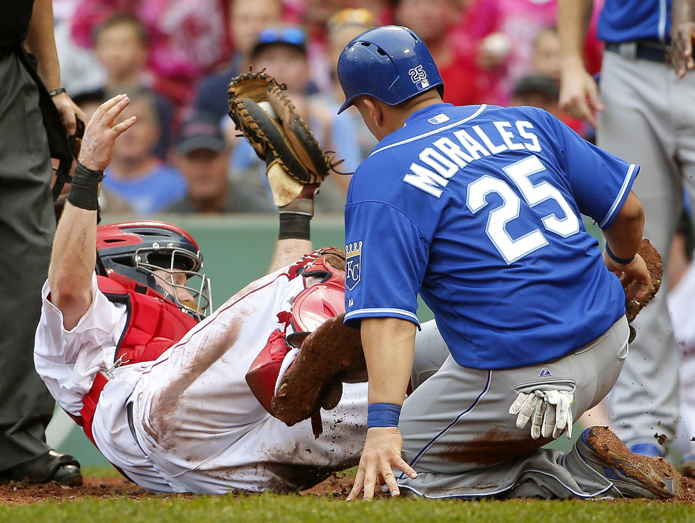 Boston Red Sox catcher Ryan Hanigan falls backward after tagging out Kansas City Royals’ Kendrys Morales in the ninth inning of Boston's 8-6 loss Sunday at Fenway Park in Boston.