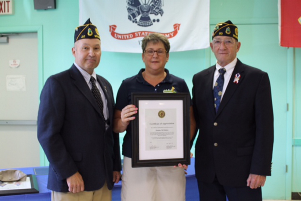Maine Region 10 Technical High School teacher and Navy veteran Joanne McMahon, center, accepts the American Legion Humanitarian Award, presented by Brunswick Legion Post 20 Past Commander Marty Diller, left, and current Post 20 Commander Joe Donahue, right. Photo courtesy Ron Caron