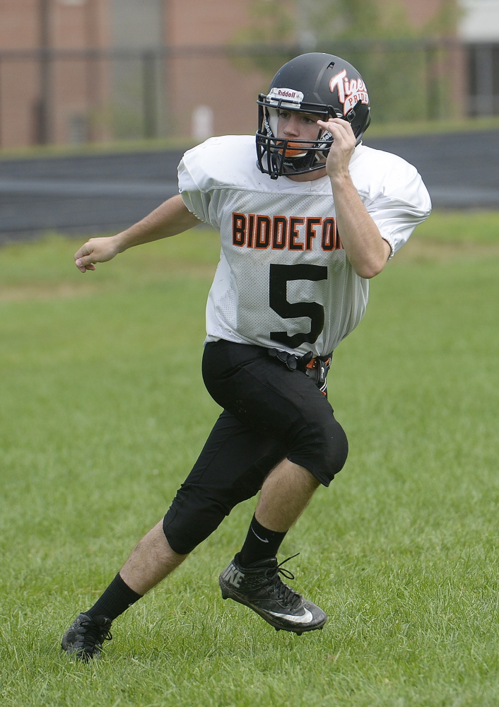 Biddeford's Jeremy Lugiano covers a receiver while running plays with the defense Saturday.