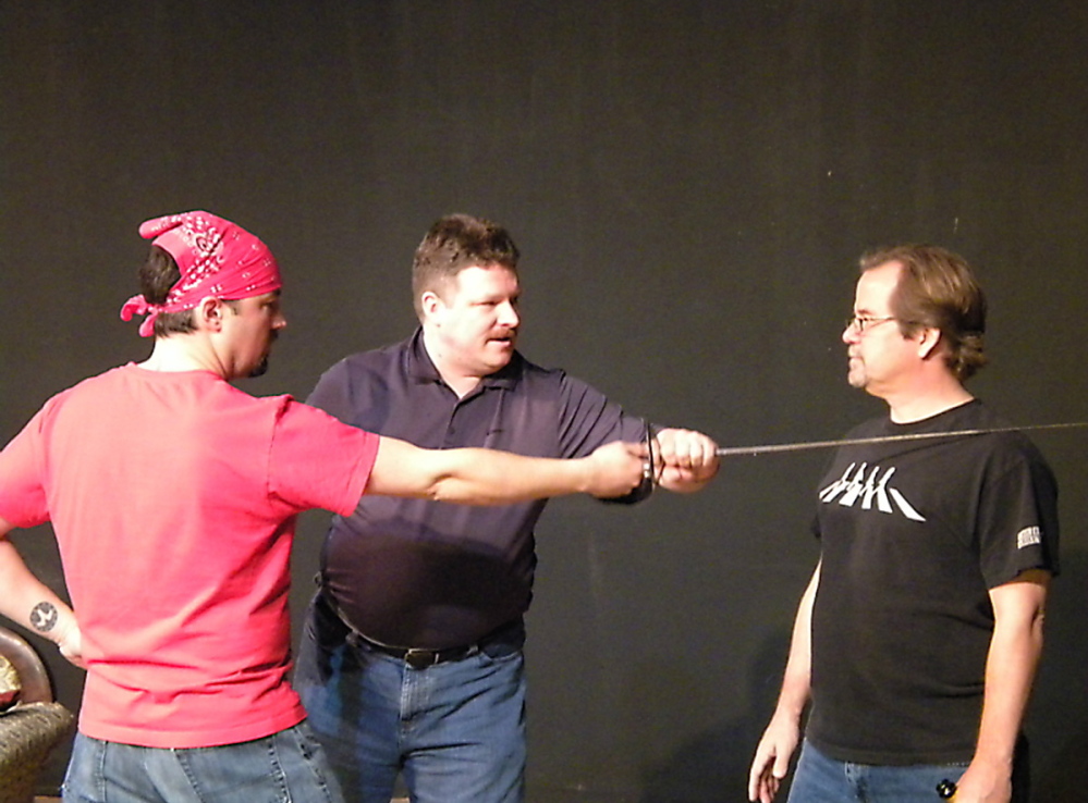 Instructor Jeffrey Eagen, center, shows actors James Paine, left, and Bart Shattuck proper combat technique during training for the Aqua City Actors Theater. The group will close its doors on Main Street in Waterville after a 17-year run at the Studio Theater in The Center.
