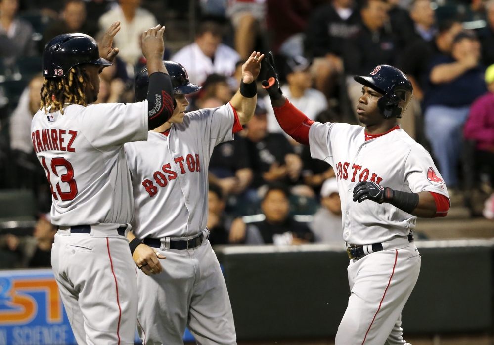Rusney Castillo, right, celebrates his three-run home run off with Hanley Ramirez, left, and Brock Holt during the Red Sox’ 5-4 victory Monday in Chicago.