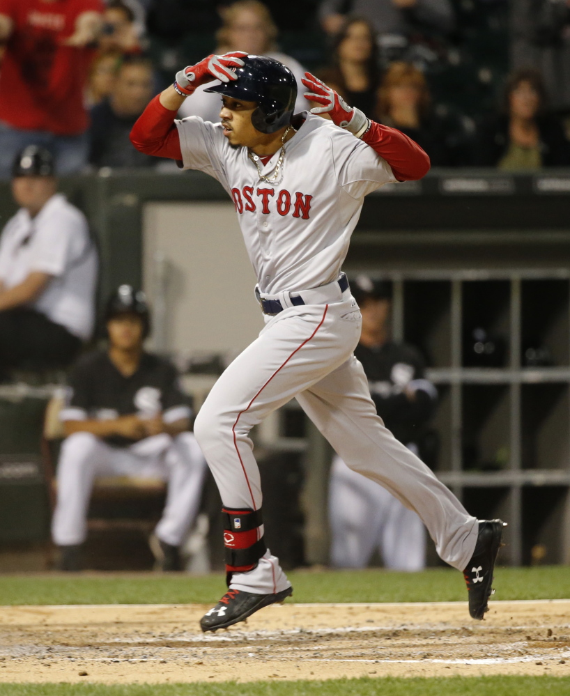Mookie Betts crosses home plate after his double and a throwing error in the third inning of the Red Sox’ 5-4 loss to the White Sox on Tuesday in Chicago.