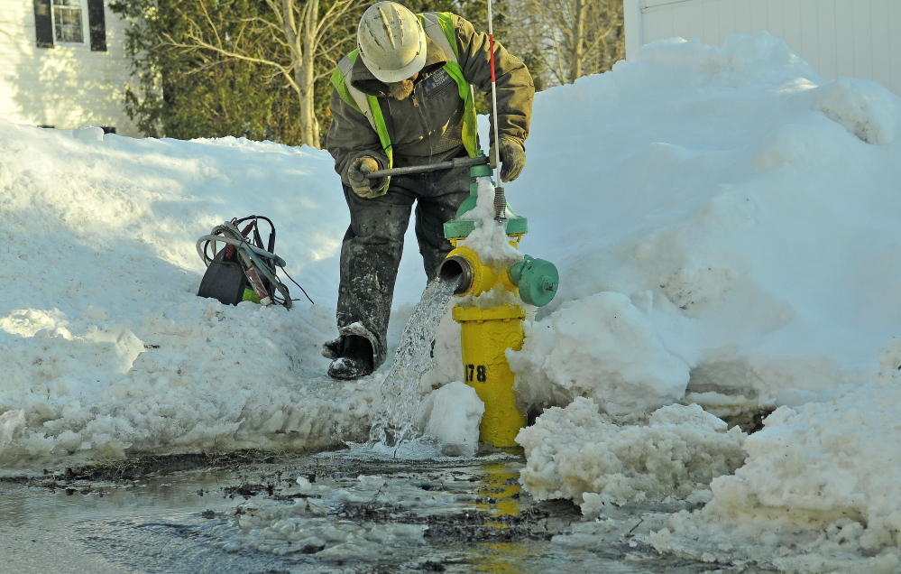 Darrell Field, of the Kennebec Water District, works on a water line in February in Waterville. Employees of the district will benefit from a $1.4 million refund from the Maine Public Employees Retirement System, which the district is putting back into retirement payments.