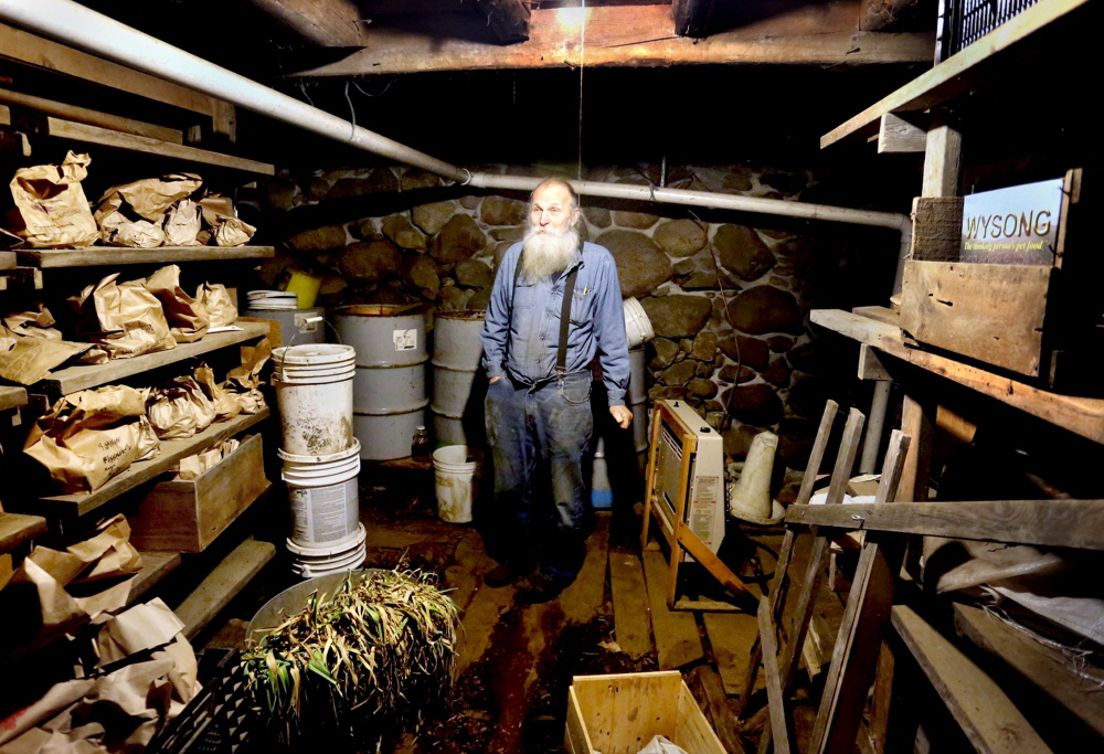 Will Bonsall in his root cellar, where he keeps hundreds of types of potatoes in brown bags to plant at his Industry farm. Maine’s seed saving guru, Bonsall will be a keynote speaker at the Common Ground Fair in late September.