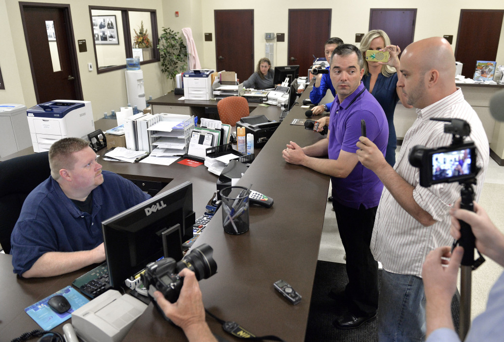 William Smith Jr., right, and his partner James Yates, center, speak with an unnamed clerk in an attempt to obtain a marriage license Thursday in Rowan County, Ky.