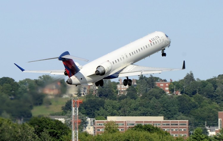 A Delta jet takes off from the Portland International Jetport, where the passenger count has bumped up in 2015 after a rough winter.