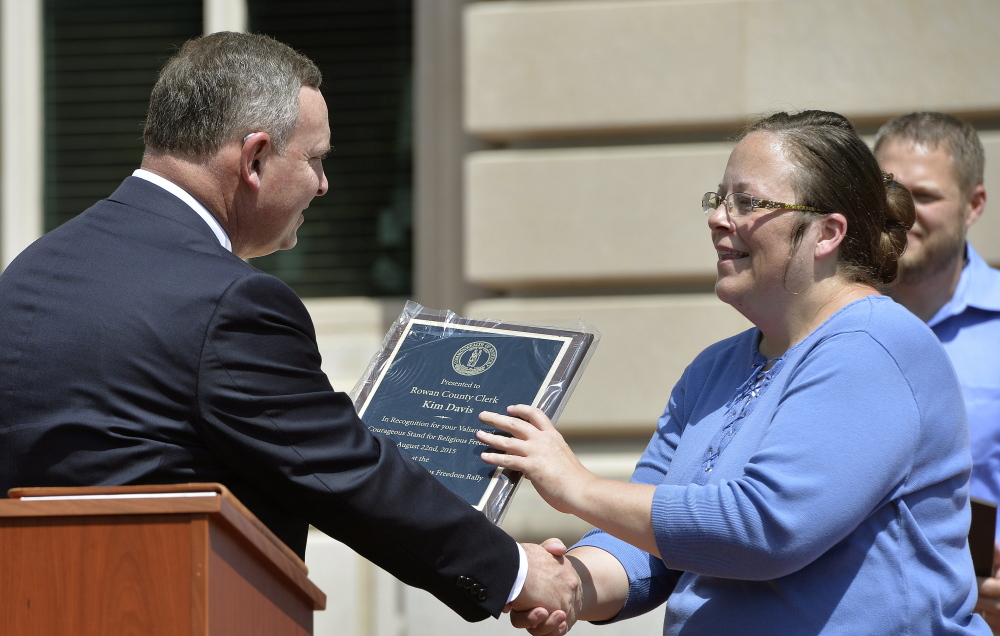 Pastor Jeffrey Fugate gives an award to Kim Davis during a Religious Freedoms Rally. Davis has been sued by the ACLU for denying marriage licenses to same-sex couples.