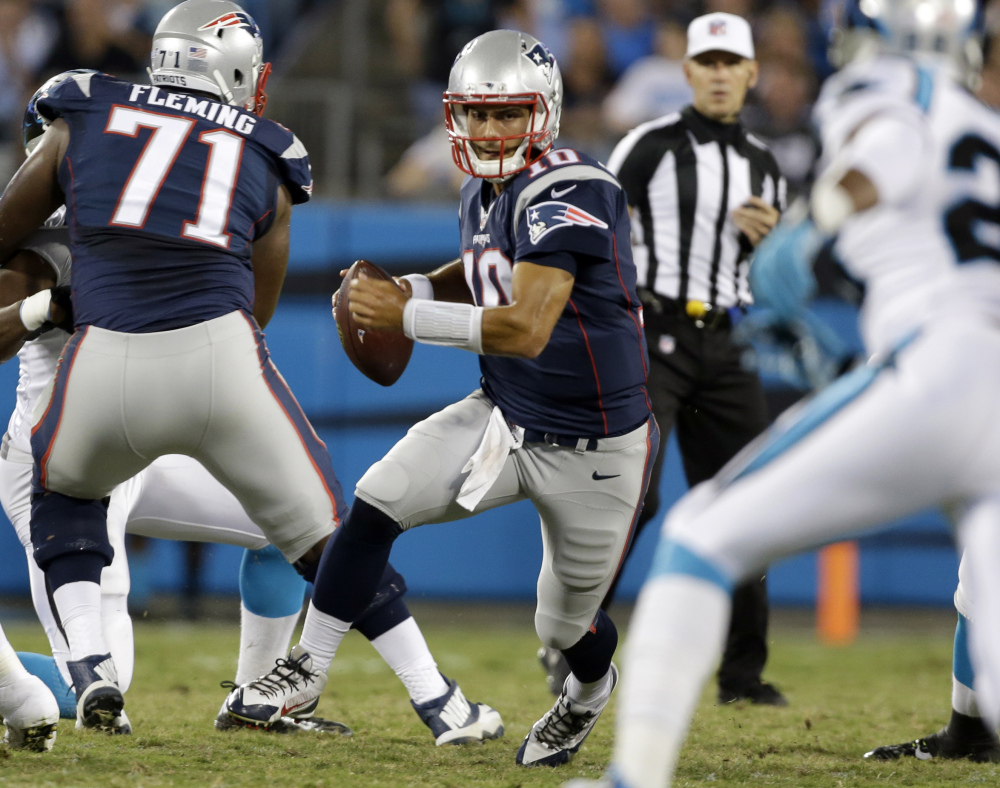 New England quarterback Jimmy Garoppolo scrambles against the Panthers in the second half.