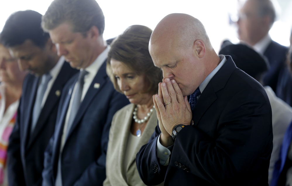 From right, New Orleans Mayor Mitch Landrieu, House Minority Leader Nancy Pelosi, Director of Office of Management and Budget Shaun Donovan and Louisiana Gov. Bobby Jindal bow in prayer during the invocation at a wreath-laying ceremony at the Hurricane Katrina Memorial on Saturday, the 10th anniversary of Hurricane Katrina in New Orleans.