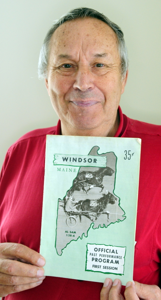 Eino Leinonen holds up a 1967 Windsor Fair racing program. He’s attended every harness race at the fair for 47 years.