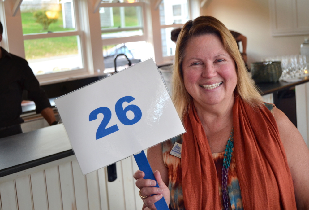 Joanne Weatherbee, supporter and volunteer for the Penobscot Bay Regional Chamber of Commerce, bids at the chamber’s 2014 auction. This year’s online event runs from Wednesday through Oct. 5; the live auction is Oct. 14.