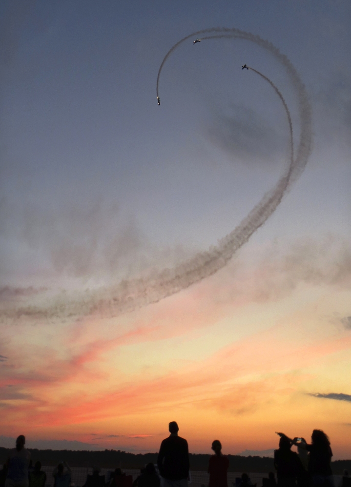 Planes perform a loop at sunset during the Great State of Maine Air Show at the former Brunswick Naval Air Station in Brunswick during its show three years ago.