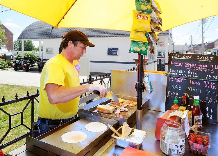 Joel Glatz owns the Yellow Cart and specializes in a grilled lobster and cheese with optional bacon, as well as fish tacos, hot dogs and crab melts. Gordon Chibroski/Staff Photographer