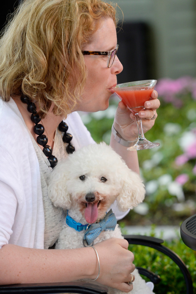 Courtney Ampezzan of Brunswick sips on a martini while her poodle Paco, who dressed for the occasion, sits on her lap during the third annual Martinis for Mutts.