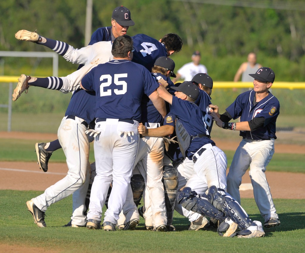 Coffee News players celebrate their 12-9 win over South Portland’s Morrill Post in the American Legion baseball state championship game Sunday. It’s the second straight state title for the Bangor-based team. John Ewing/Staff Photographer