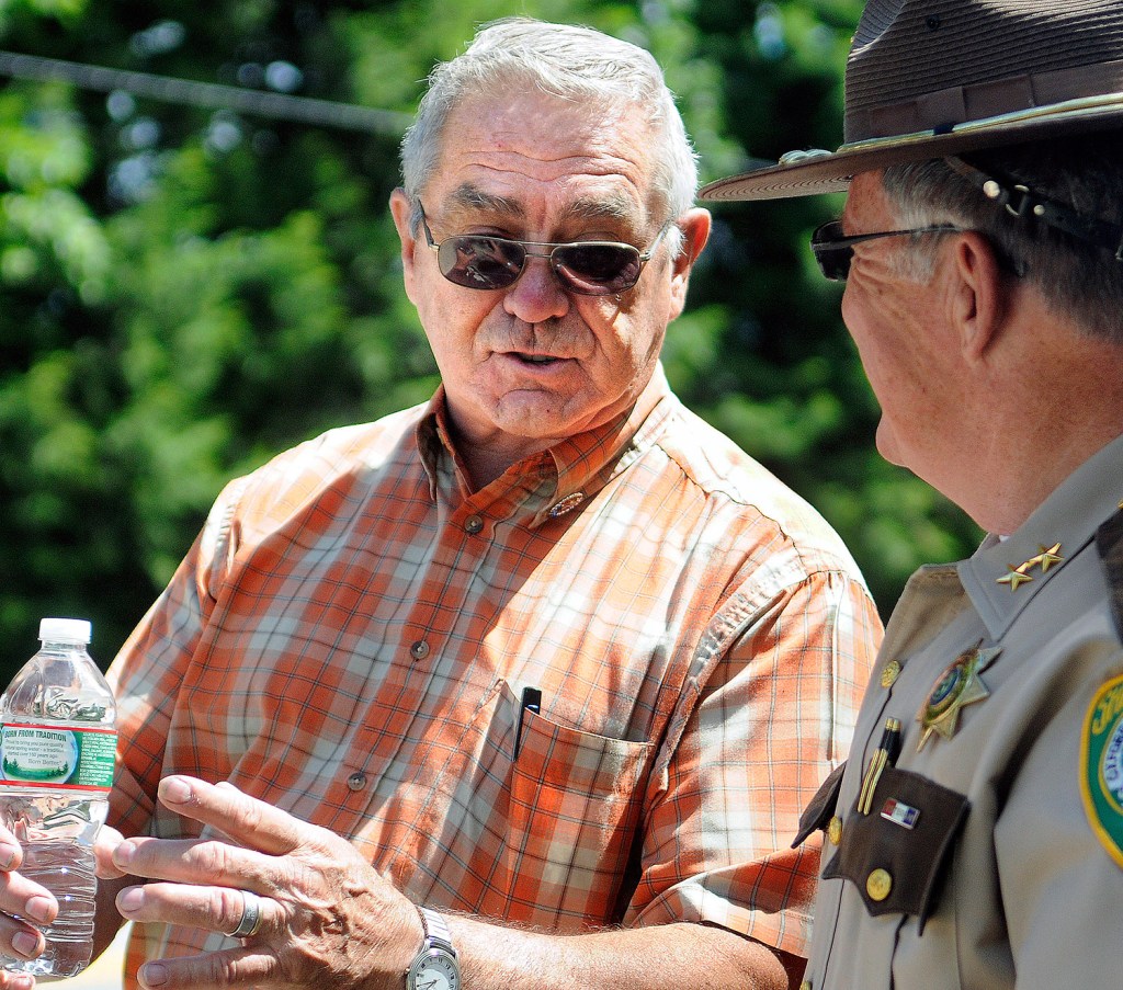 Kim Moreau's father, Dick, speaks with Oxford County Sheriff Wayne Gallant on Thursday across from a home on Route 108 in Canton where police searched for her remains.
Andy Molloy/Kennebec Journal
