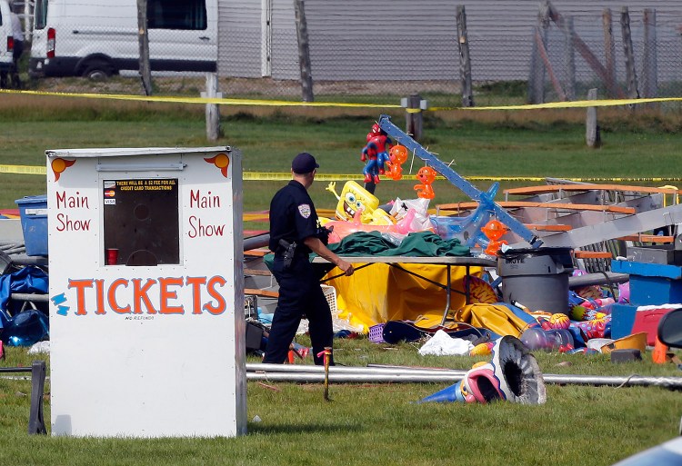 Investigators on Tuesday inspect the site of a circus tent that collapsed Monday during a show by the Walker Brothers International Circus at the Lancaster Fairgrounds in Lancaster, N.H.