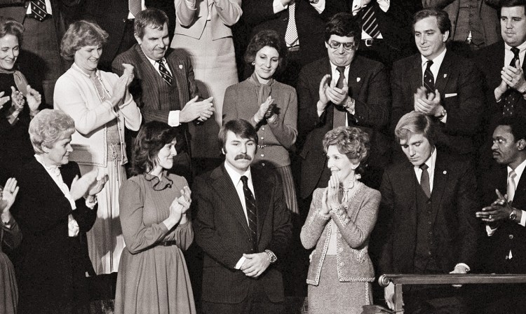 In this 1982 photo, Lennie Skutnik, center front,  the man who jumped into the Potomac River and saved one of the passengers aboard the Air Florida jetliner that crashed, receives applause from first lady Nancy Reagan and other dignitaries in Washington. The Associated Press