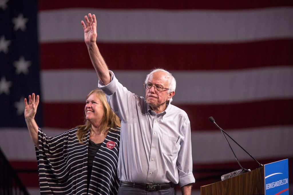 Democratic presidential candidate Sen. Bernie Sanders, with his wife Jane, waves at a rally at the Los Angeles Memorial Sports Arena.