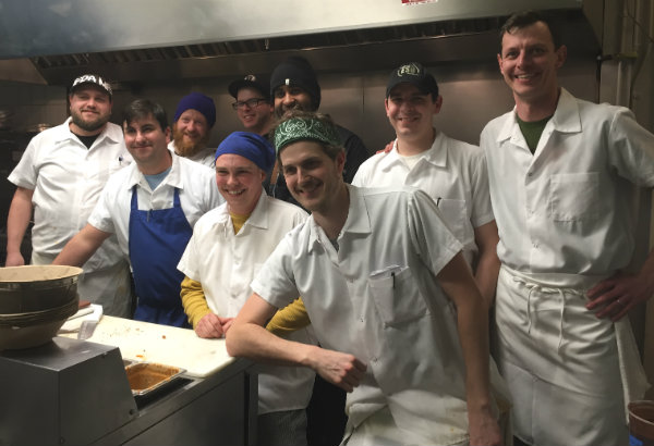 Chef-owners Karl Deuben, far right, and Bill Leavy, in blue apron, with their crew in the East Ender kitchen. Press Herald file photo
