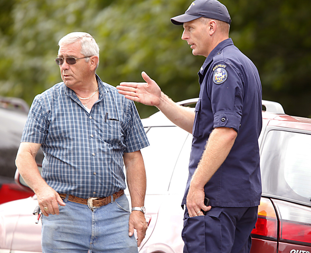 Richard Moreau, father of Kimberly Moreau who has been missing since 1986, and a Maine State Police investigator, talk outside a Rt. 108, Canton scene where Maine law officials were searching on Sunday. Carl D. Walsh/Staff Photographer