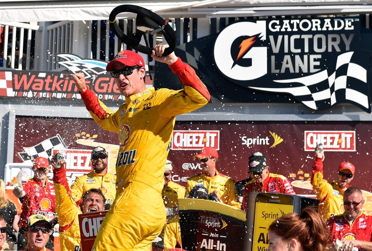 Joey Logano celebrates in Victory Lane after winning a NASCAR Sprint Cup series auto race at Watkins Glen International Sunday. The Associated Press