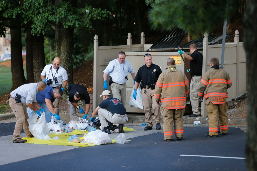 Investigators search trash from a bin near the apartment of Vester Lee Flanagan II, in Roanoke, Virginia, on Wednesday.  Flanagan filmed himself gunning down a WDBJ-TV reporter and cameraman during a live broadcast Wednesday and posted the video on social media.
The Associated Press